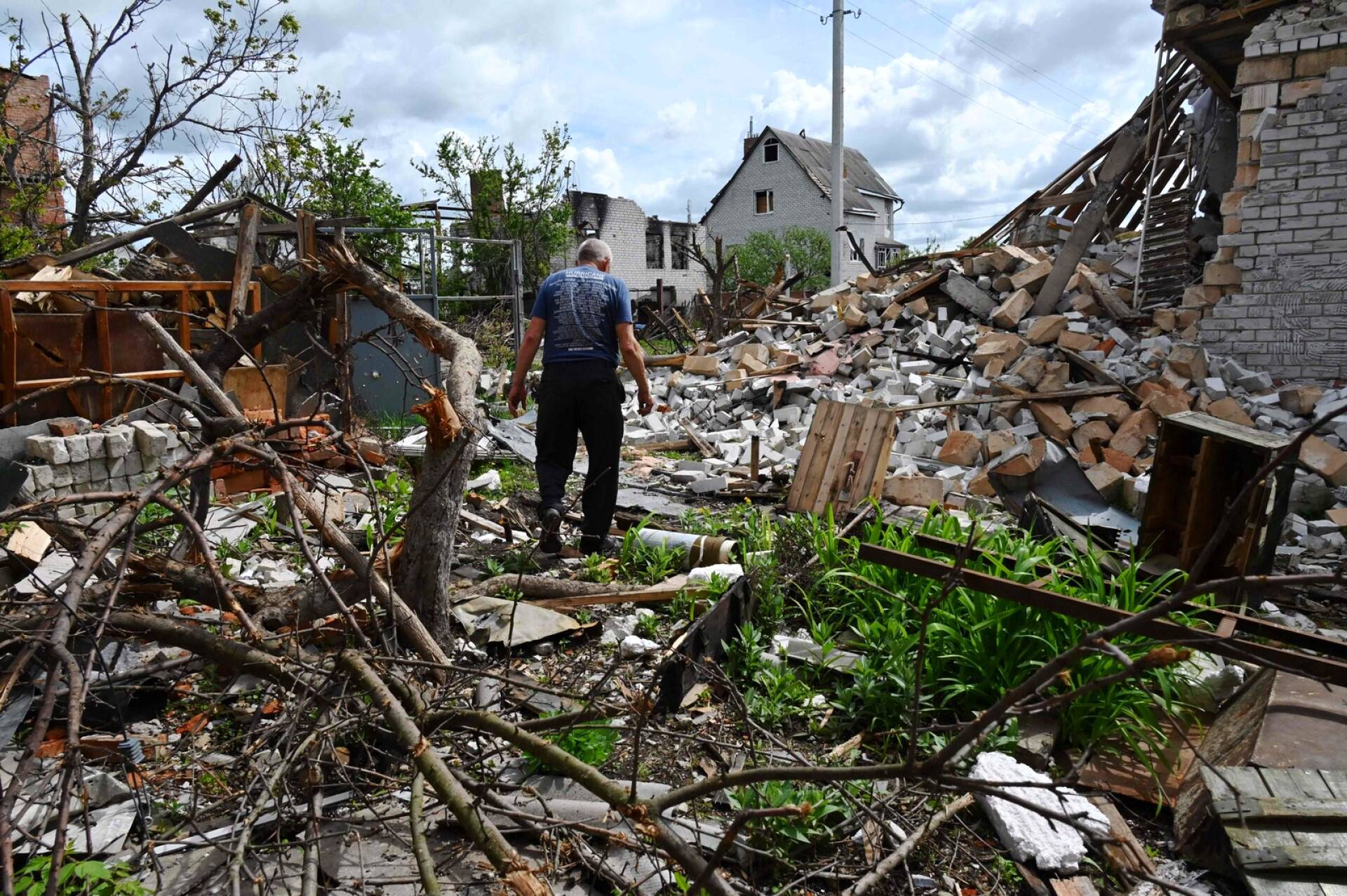 Mies tutkii pommituksessa tuhoutuneen asuntonsa pihaa Mala Roganin kylässä Harkovan lähellä.