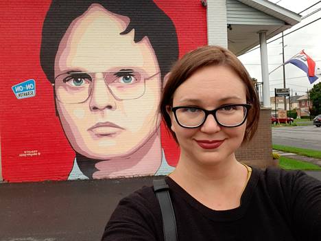 The reporter took a selfie in front of the mural.