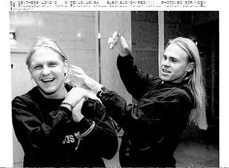 Kim Suominen (vas.) tuli tunnetuksi vaaleista pitkistä kutreistaan, joita hänen ystävänsä ja pelikaverinsa Marko Rajamäki leikillään on kuvassa leikkaamassa.