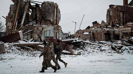 Ukraina vapautti Kupjanskin syyskuussa. Nyt venäläisjoukot uhkaavat sitä jälleen. Kuvassa ukrainalaissotilaita sodassa tuhoutuneen rakennuksen edessä.