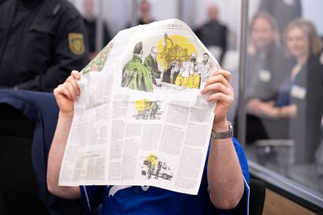 The accused covered his face with newspaper in the court.