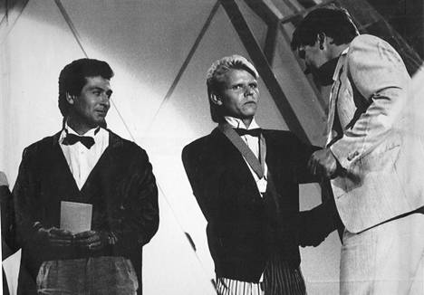 Tangoprinssi Rainer Friman (vas.) katsoo, kuinka tangokuningas 1986 Teuvo Oinas vastaanottaa onnitteluja.