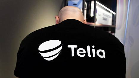 Teleoperaattori Telian eli vanhan Soneran uusi logo työntekijän selässä tiedotustilaisuudessa Kampissa maaliskuussa.