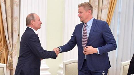 Peter Schmeichel (oik.) ojensi kätensä Vladimir Putinille.
