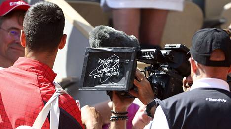 ”Kosovo on Serbian sydän. Lopettakaa väkivalta”, Novak Djokovic kirjoitti maanantaina kameran linssiin. Teksti heijastettiin myös videotaululle yleisön nähtäväksi.