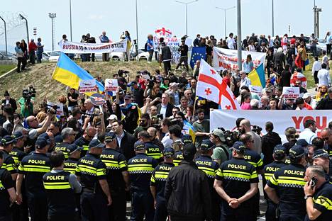 There were scuffles between protesters and police at Tbilisi airport on Friday.