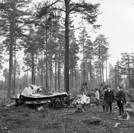 Onnettomuuskoneen jäännöksiä tutkitaan metsässä.