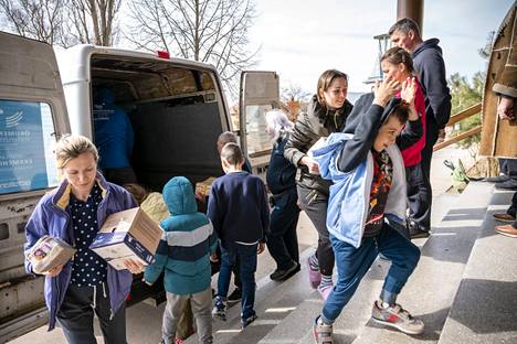 Kirkon Ulkomaanavun kumppanijärjestö toimittaa elintarvikkeita ja vaippoja Velyki Beregyn kylässä sijaitsevalle koululle, joko toimii nyt pakolaissuojana. Sotaa paenneet ihmiset auttavat purkamaan lastia.