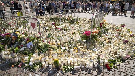 Puukotuksen tapahtumapaikoille Turun keskustassa on tuotu kynttilöitä ja kukkia.