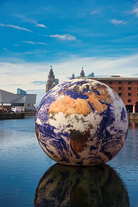 Luke Germ's Floating Earth adorns the Albert Dock Harbor area, which serves as the venue for the competition.
