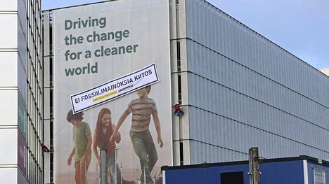 Fortumin mainoksen päälle ripustettu Greenpeacen fossiilimainontaa vastustava banderolli Helsinki-Vantaan lentoasemalla 24. marraskuuta 2021. 